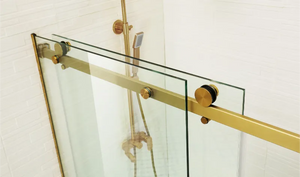 COVEY WALL TO WALL FRAMELESS SINGLE SLIDING DOOR BATH SCREEN BRUSHED GOLD