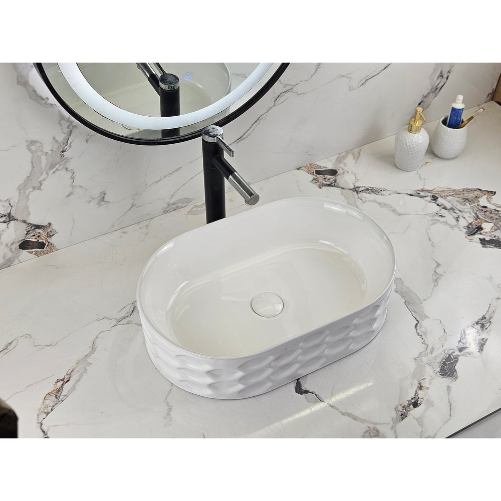 Infinity IA103 oval textured gloss white basin with black tapware, left angled view