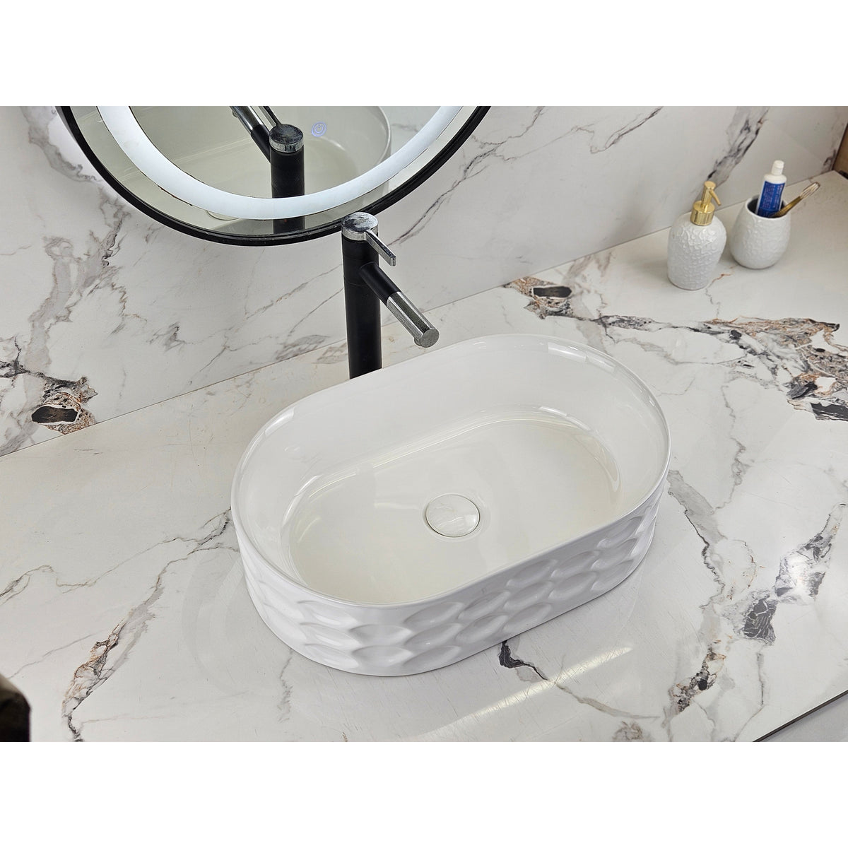 Infinity IA103 oval textured gloss white basin with black tapware, left angled view
