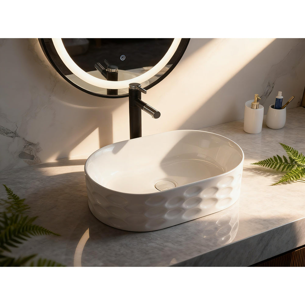Infinity IA103 oval textured gloss white basin styled on a marble vanity